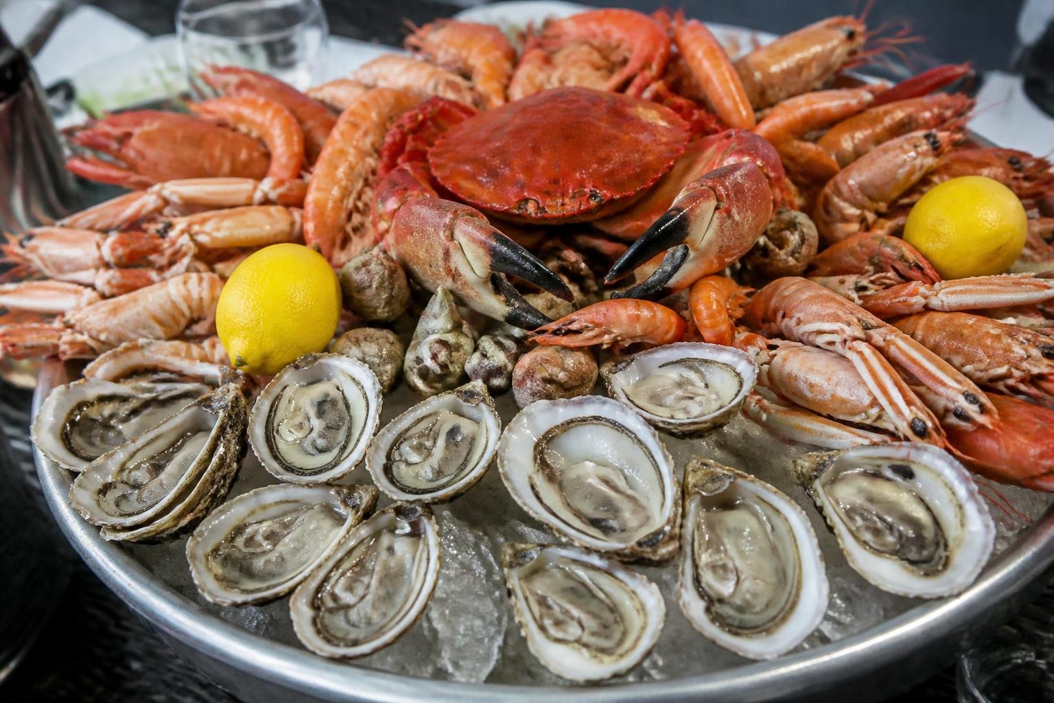 Plateau de fruits de mer garni d'huîtres, crevettes et crustacés sur lit de glaçons